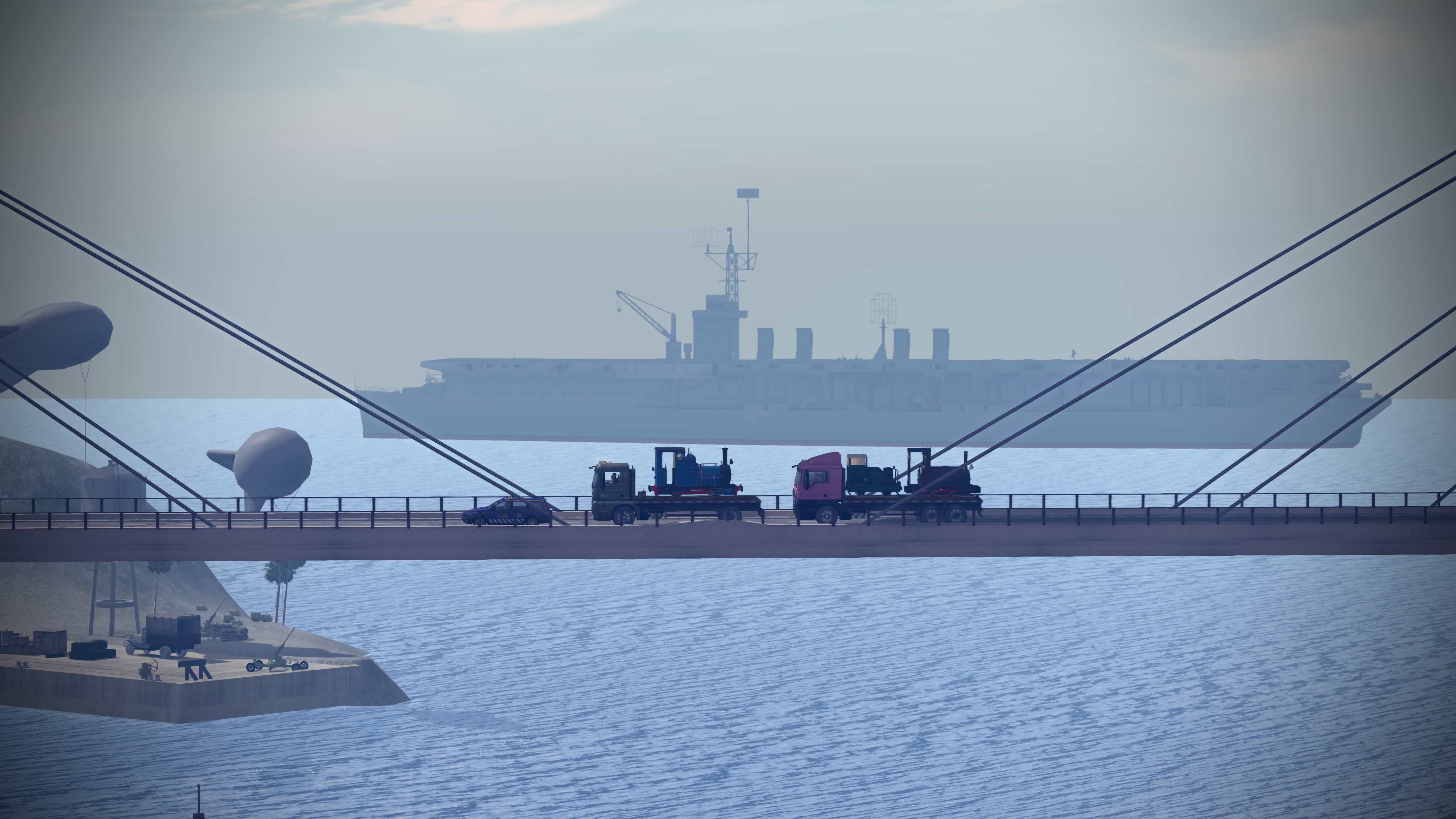 The Zany Zen Railway Locomotive Transport Convoy on the Lordshore Suspension Bridge with a view of Jeogeot Gulf behind and the USS Reprisal in the background